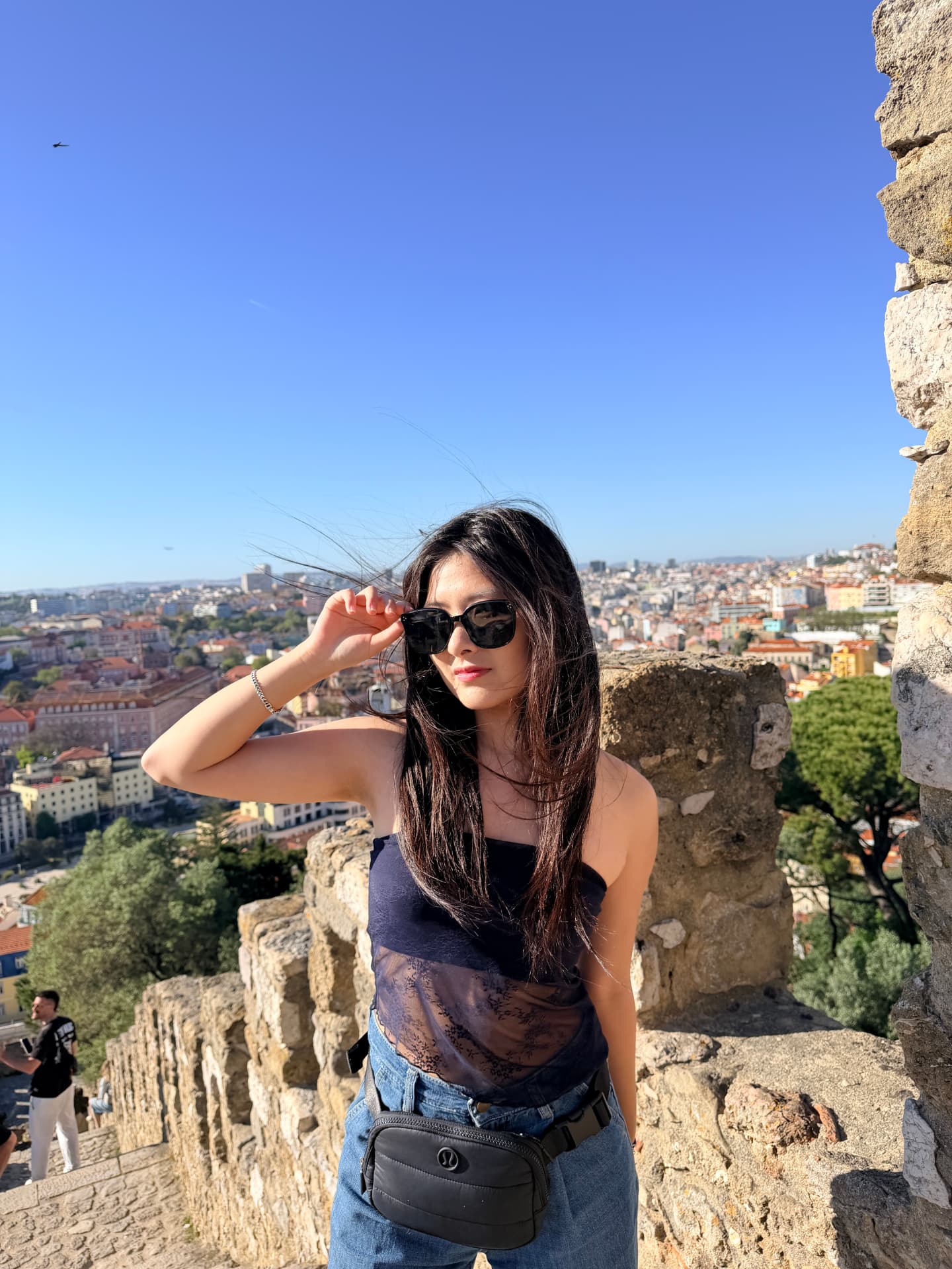 Josephine overlooking Lisbon from a castle wall