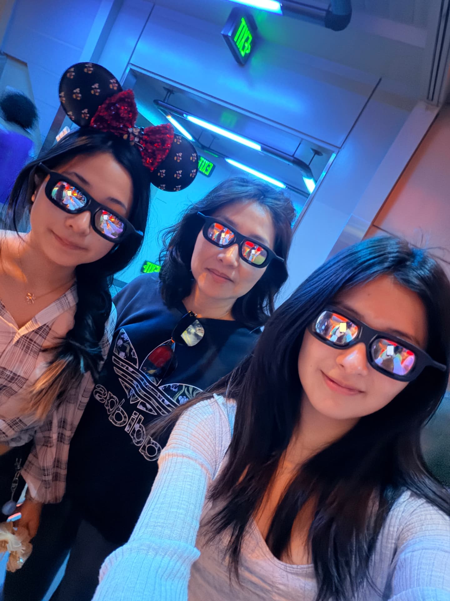 Josephine with family wearing 3D glasses at a Disney attraction