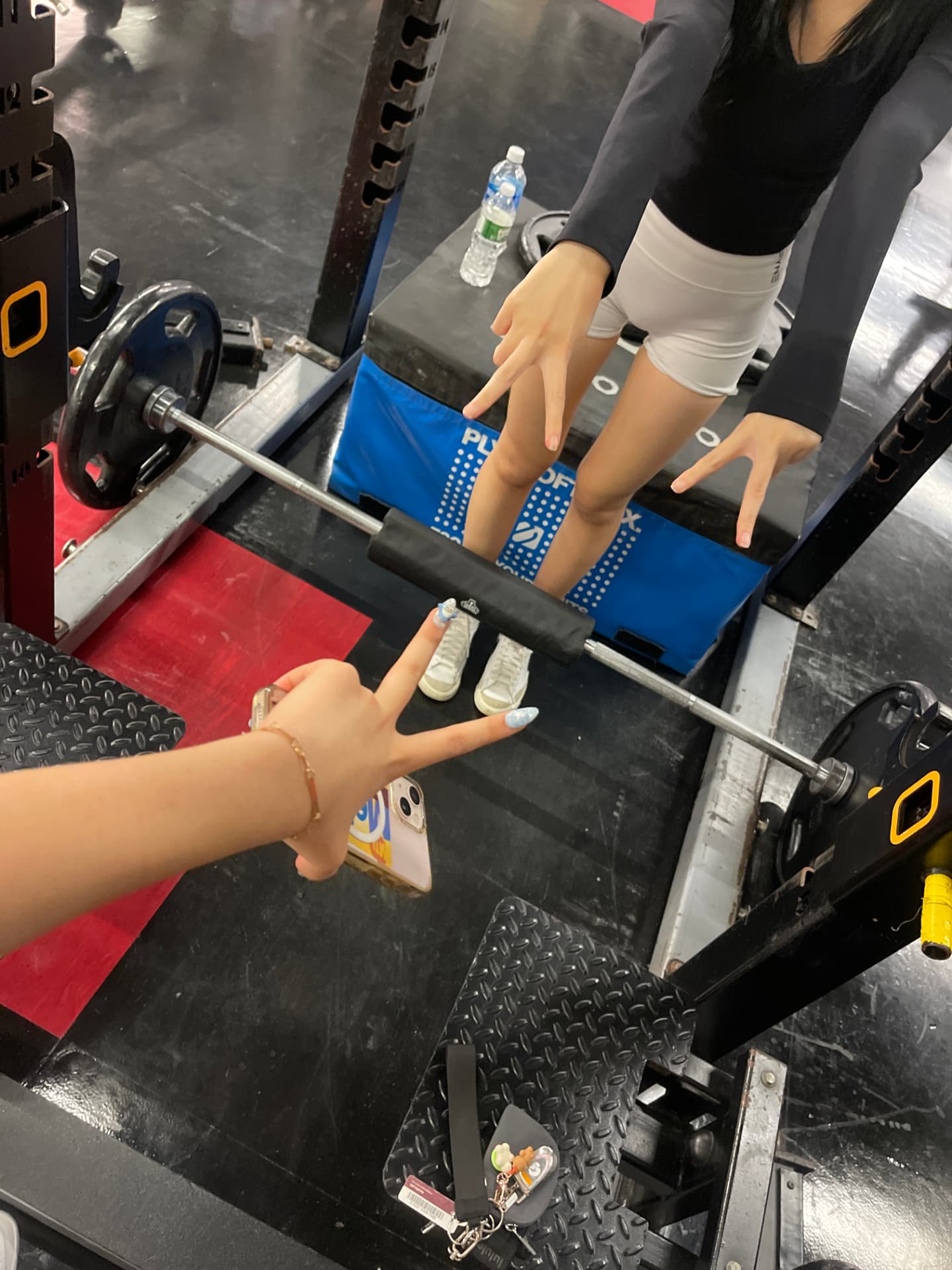 Gym mirror photo at the squat rack with friends